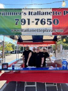 Four people wearing black shirts in Italianette vendor booth