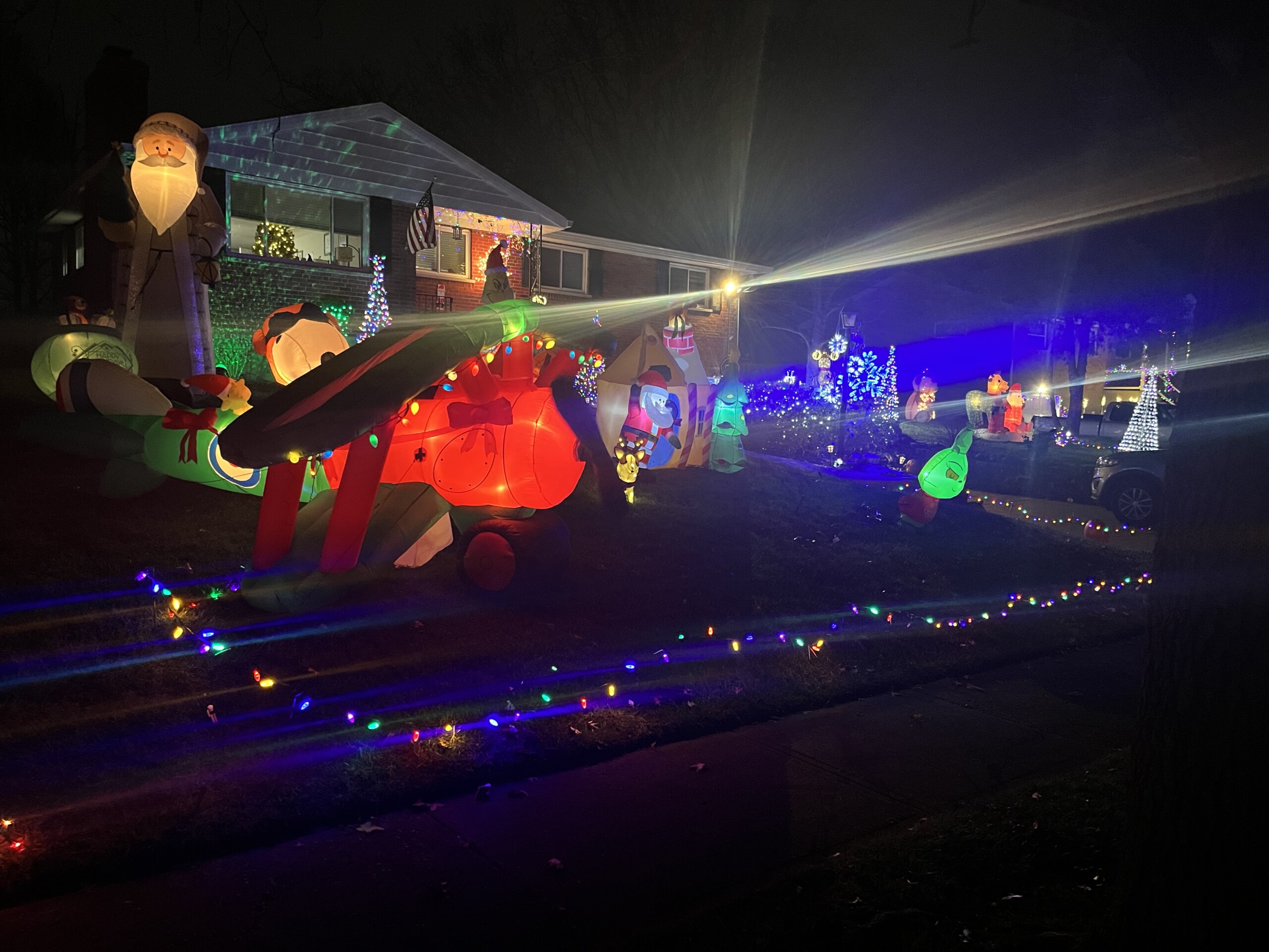 house with holiday lights and blow up airplane