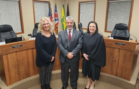 Newly elected Trustee Tracy Kellums with his wife, Karen, and Hamilton County Common Please Court Judge Shanahan.