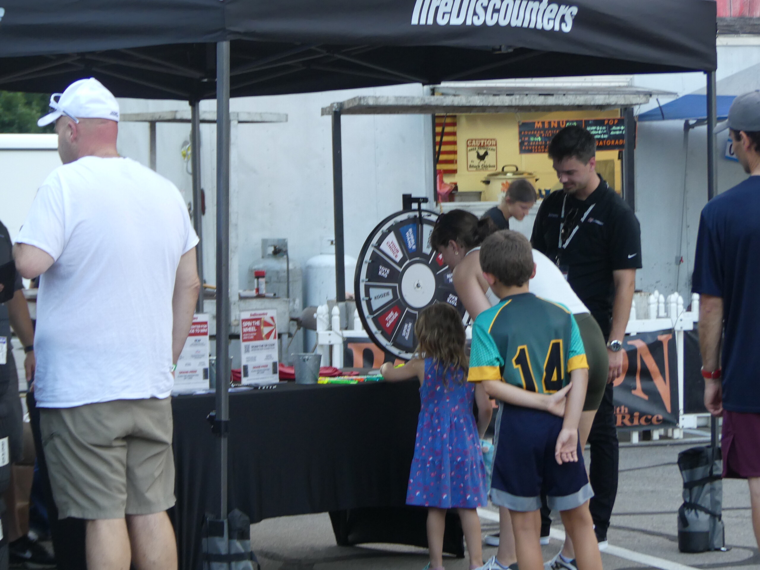 Tire Discounters w kid spinning the wheel 2